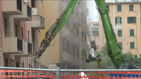 Demolizione palazzine via Porro: pinza meccanica in azione